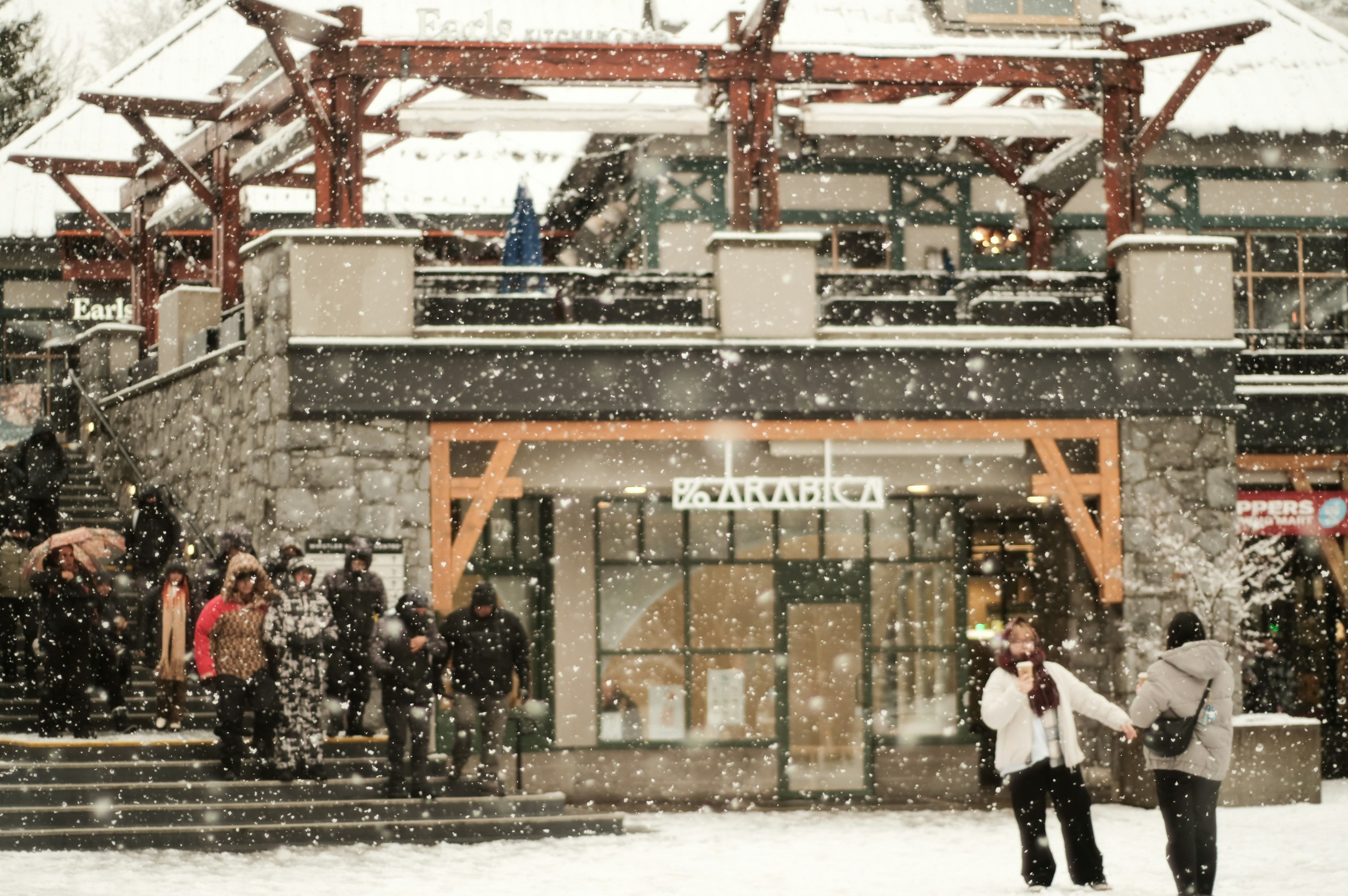 A group of people walking across a snow covered street