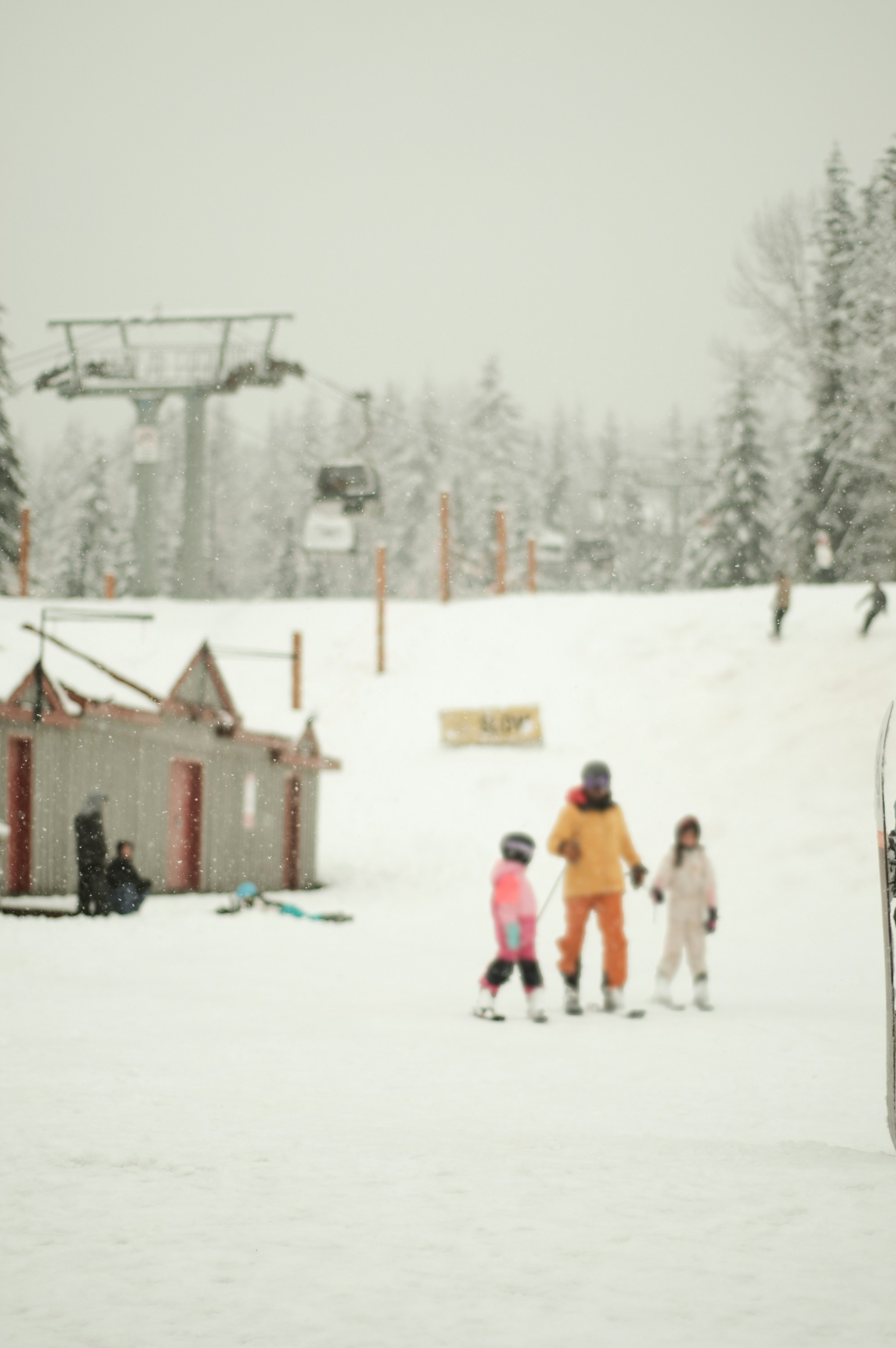 A group of people riding skis on top of a snow covered slope