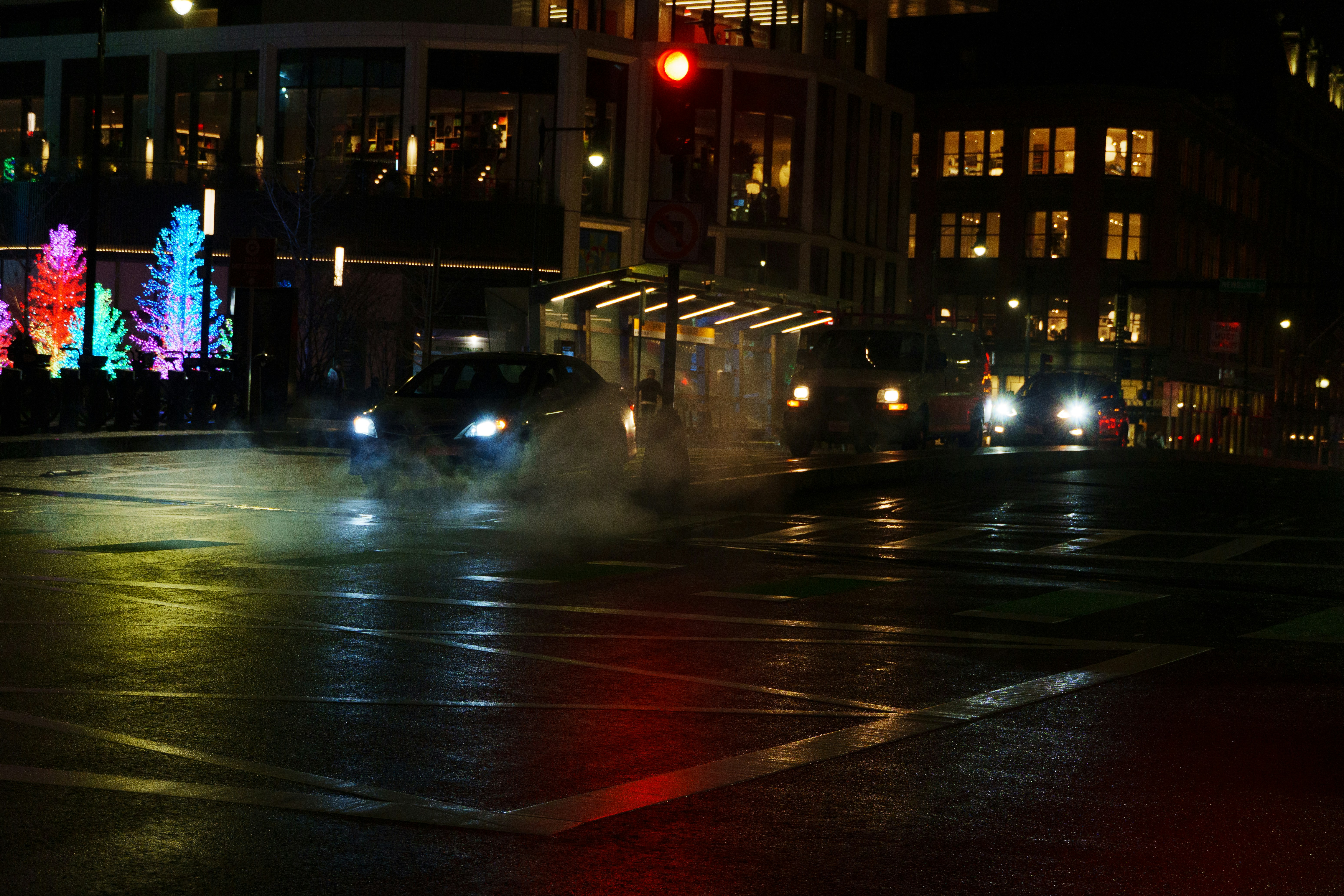 A city street at night with a traffic light
