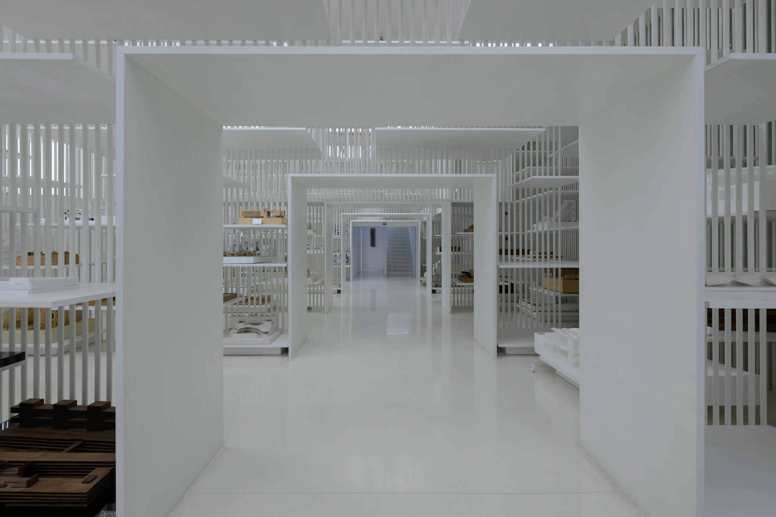 A white interior model showing layered screens and openings