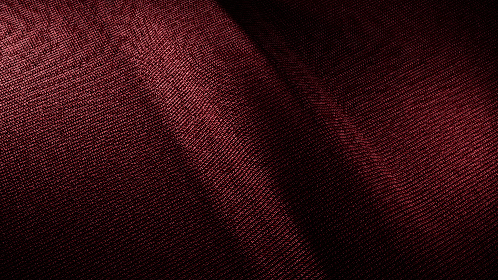 A close up of a red cloth with a black background