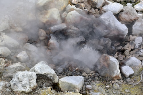 A man standing next to a pile of rocks