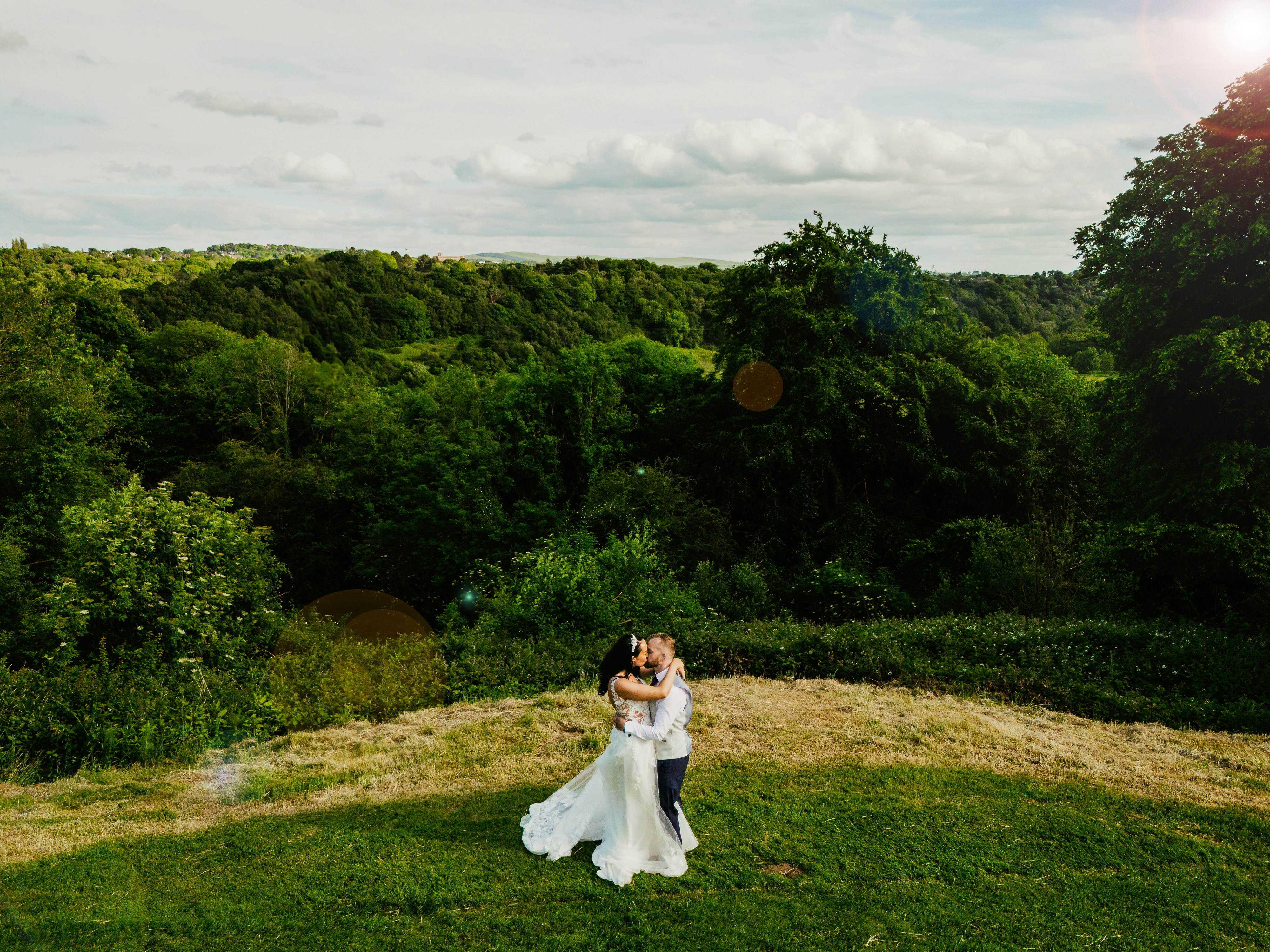 A bride and groom standing in a field