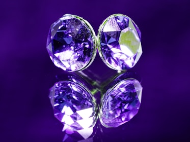 A pair of purple diamonds sitting on top of a table
