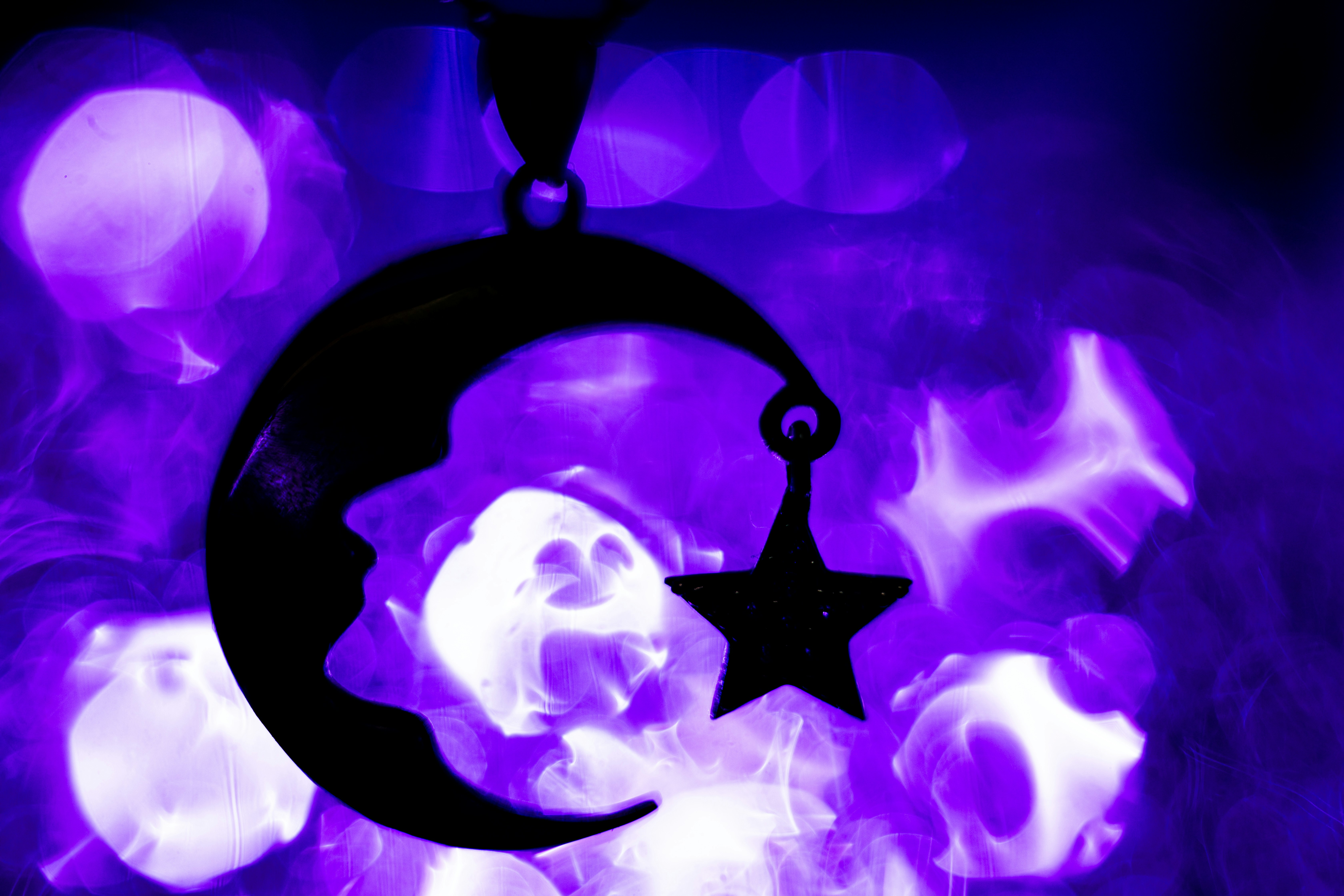 A black and purple picture of a crescent and star