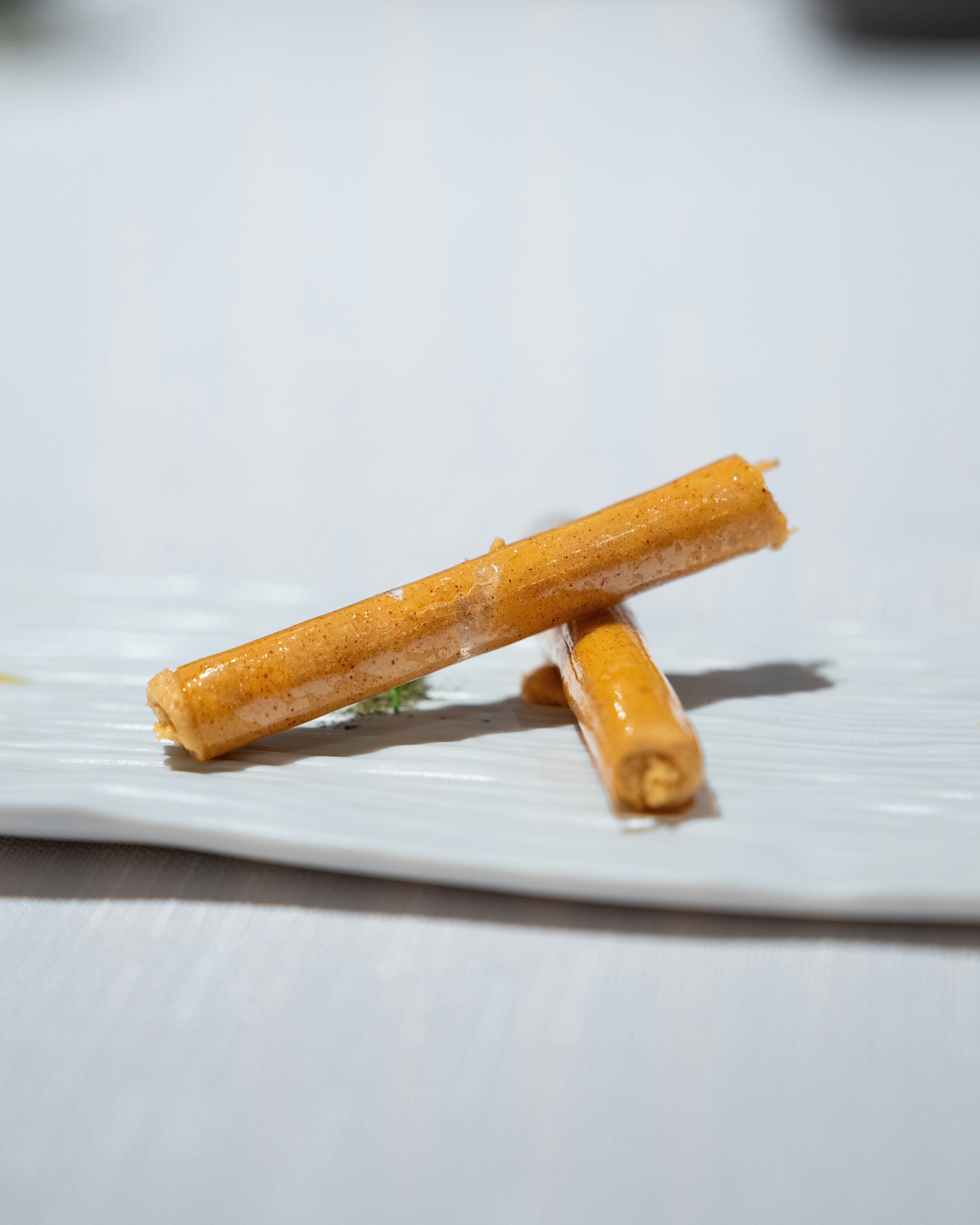 Crispy golden spring rolls with dipping sauce, bright studio background