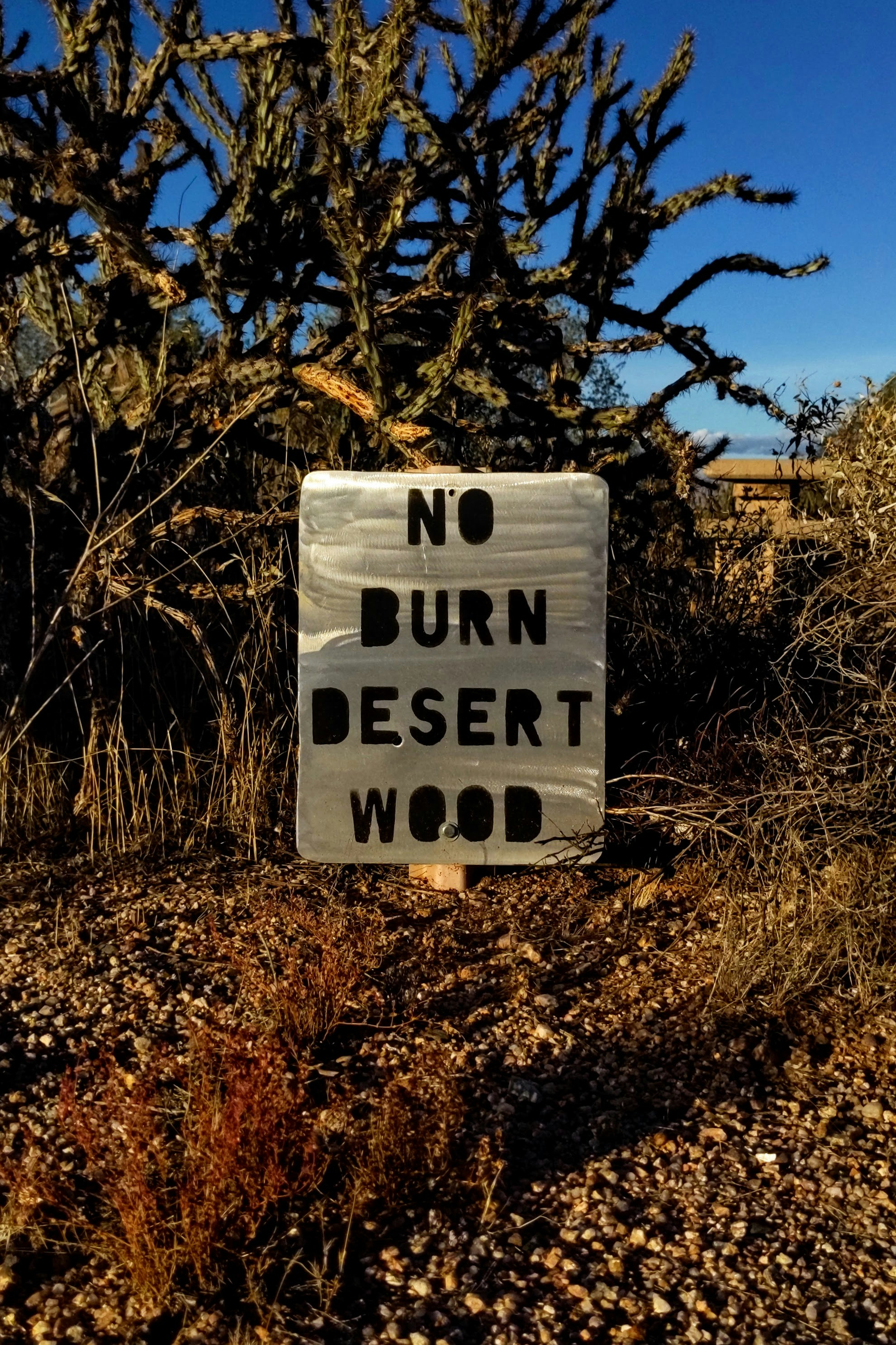 A sign that says no burn desert wood