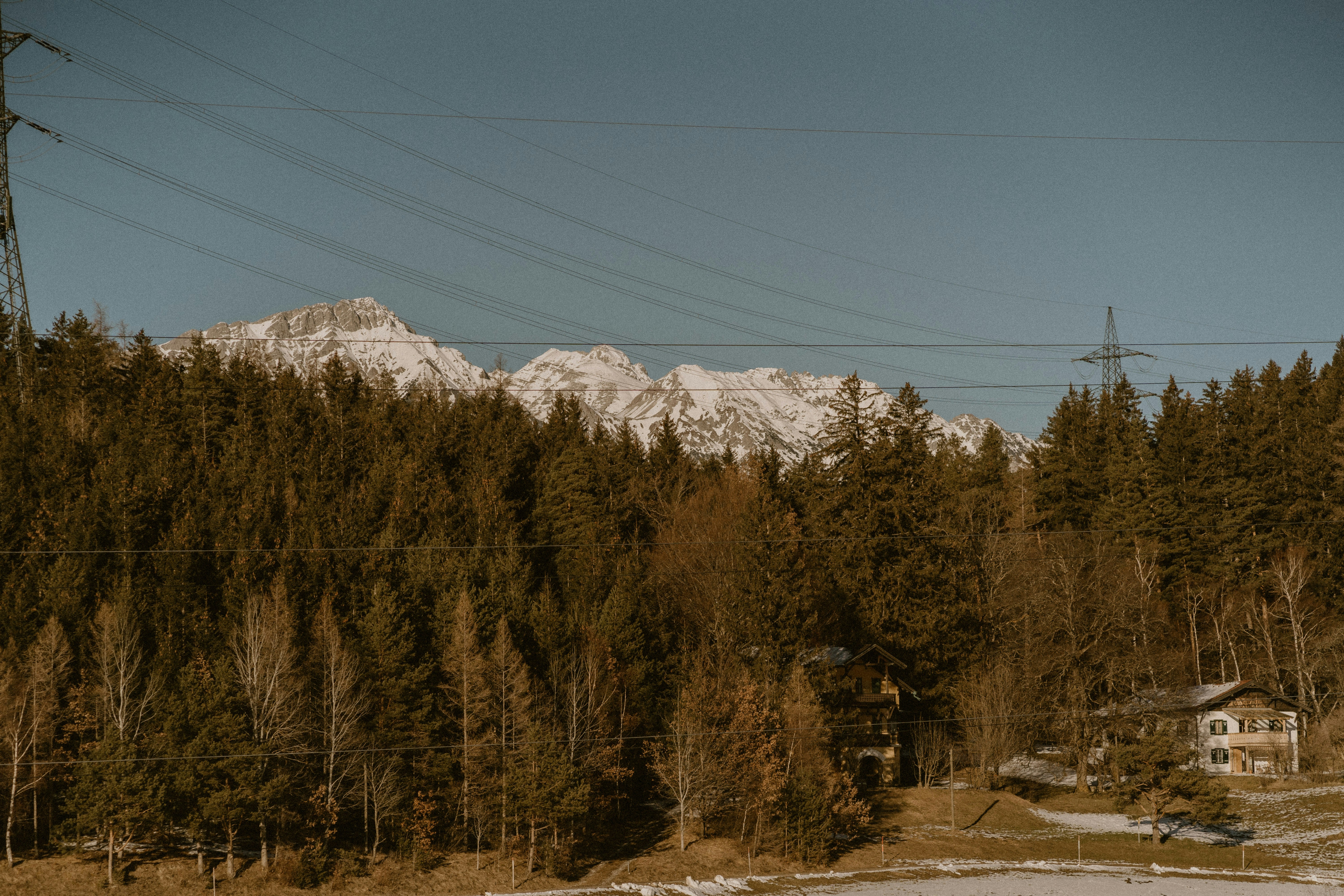 A snow covered field with a mountain in the background
