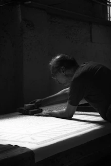 A man laying on top of a mattress in a room