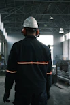 A man in a factory wearing a hard hat