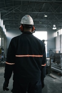 A man in a factory wearing a hard hat