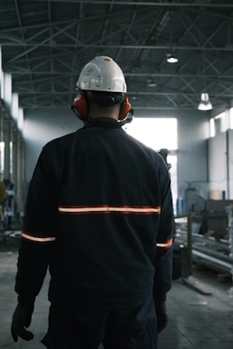 A man in a factory wearing a hard hat