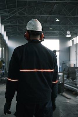A man in a factory wearing a hard hat