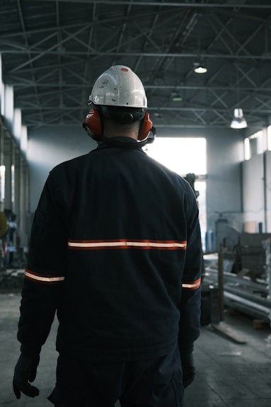 A man in a factory wearing a hard hat