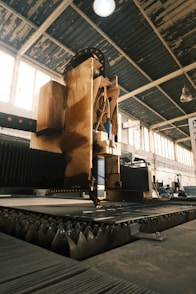 A large machine in a large building with lots of windows