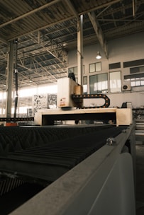 A large machine in a large building with lots of windows