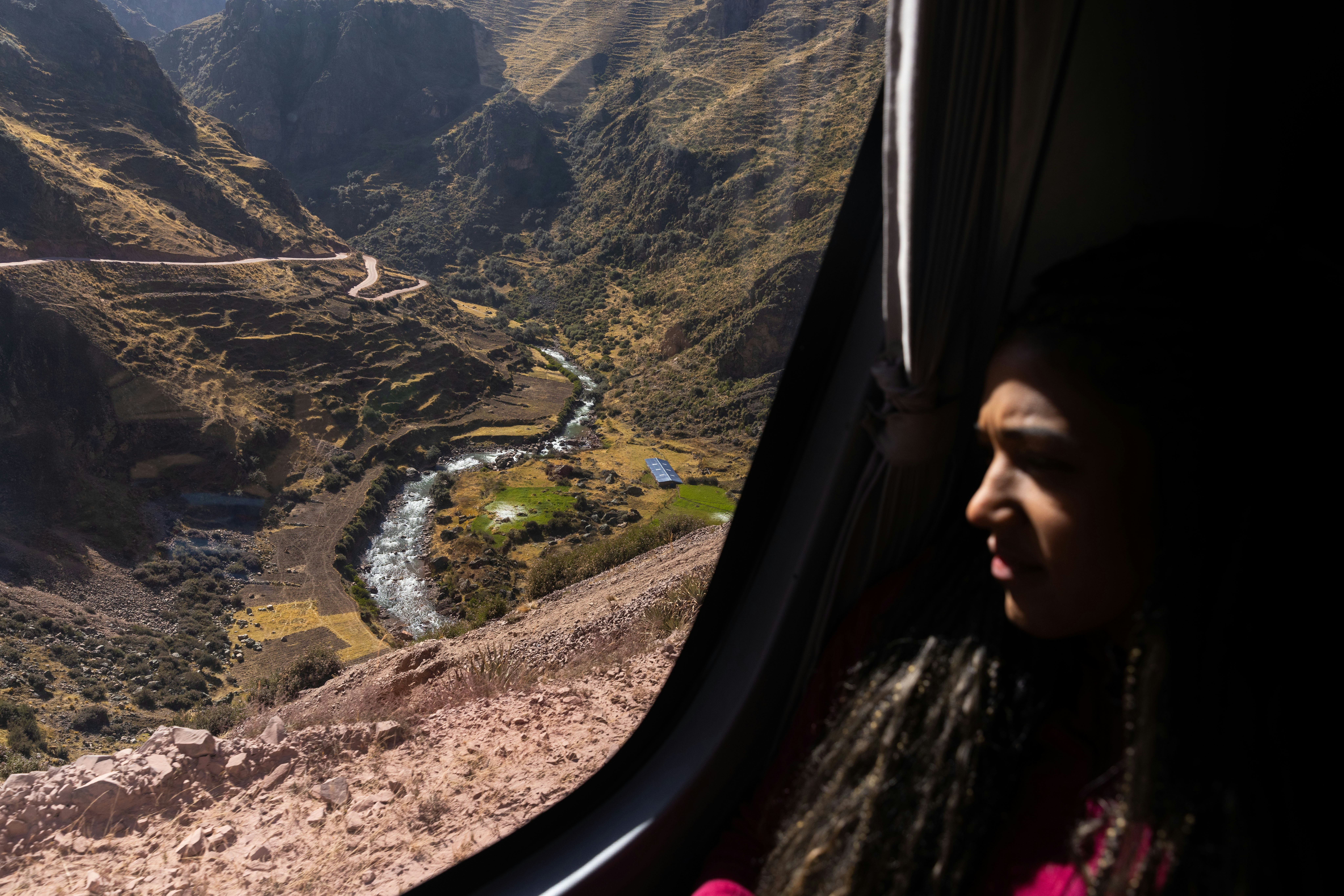 A woman looking out the window of an airplane