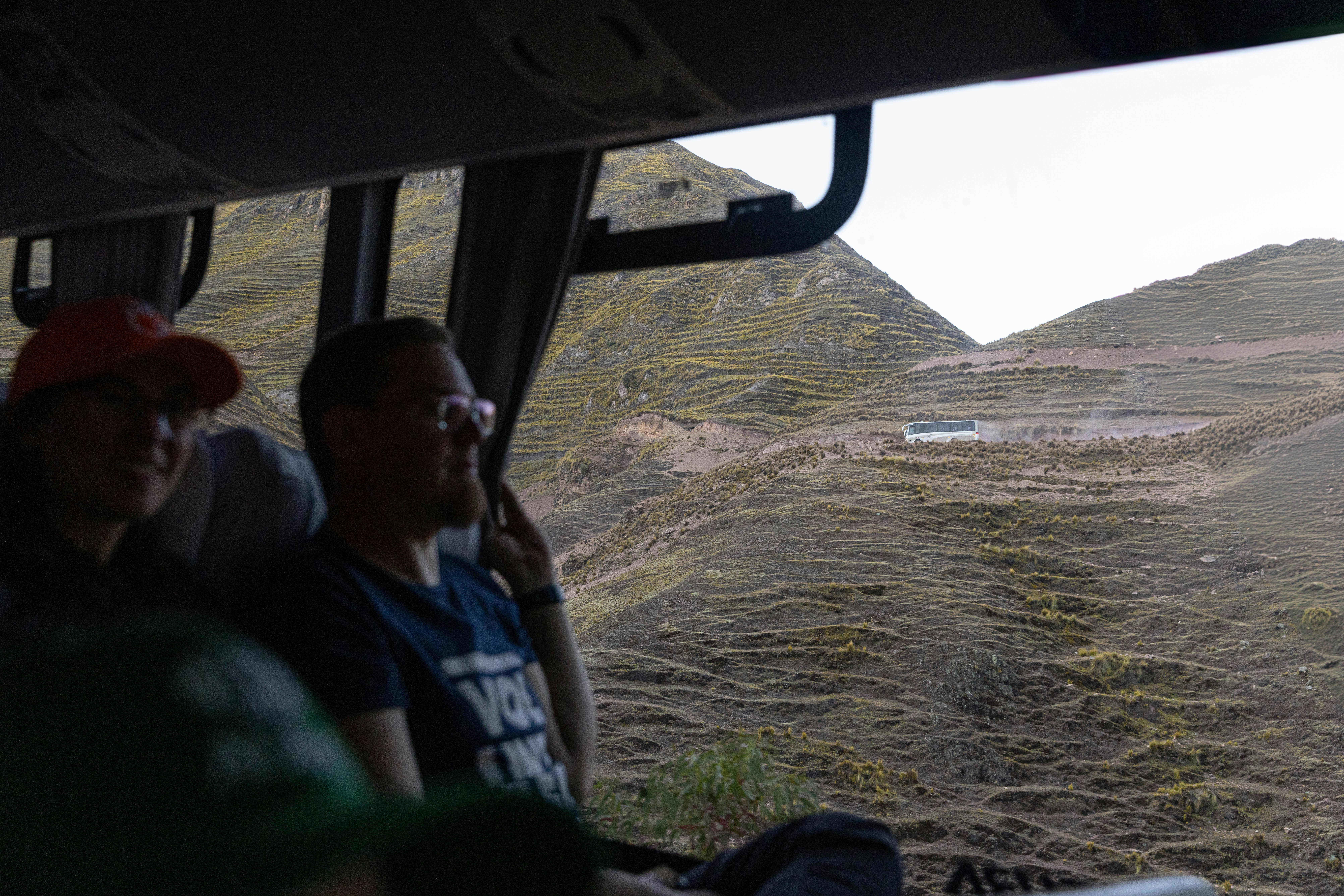 A group of people riding on the back of a bus