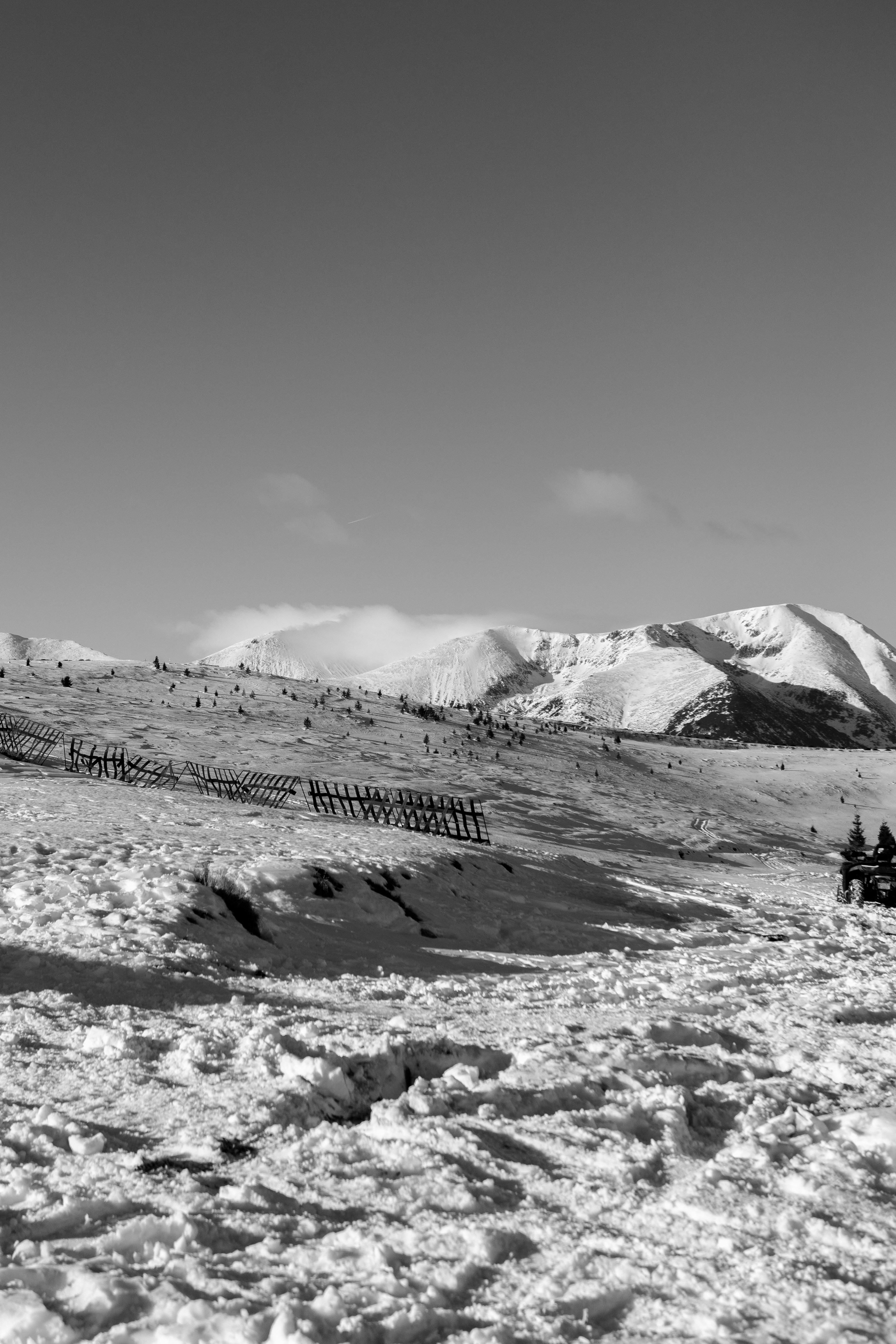 A black and white photo of snow covered mountains
