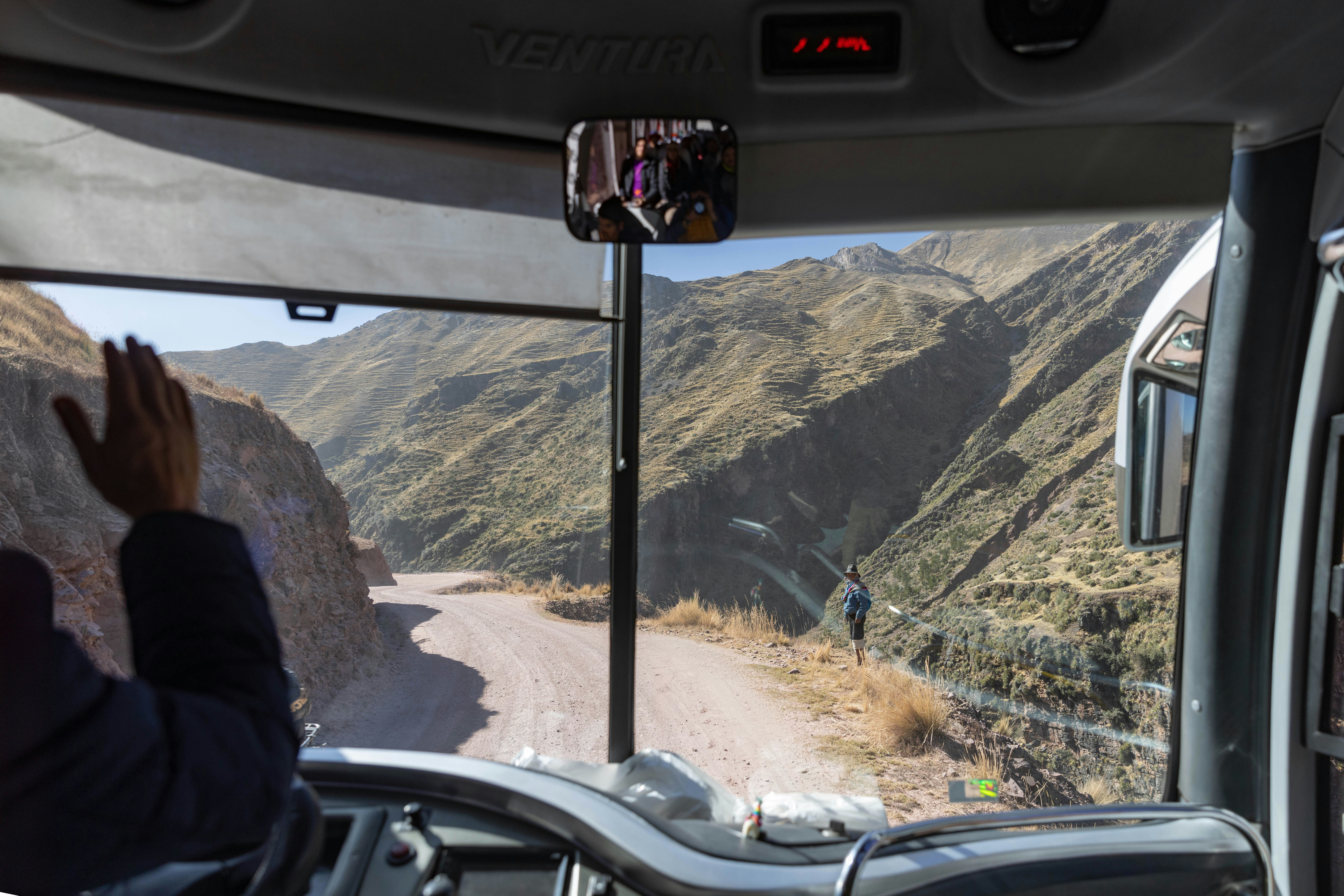A person sitting in a bus looking out the window