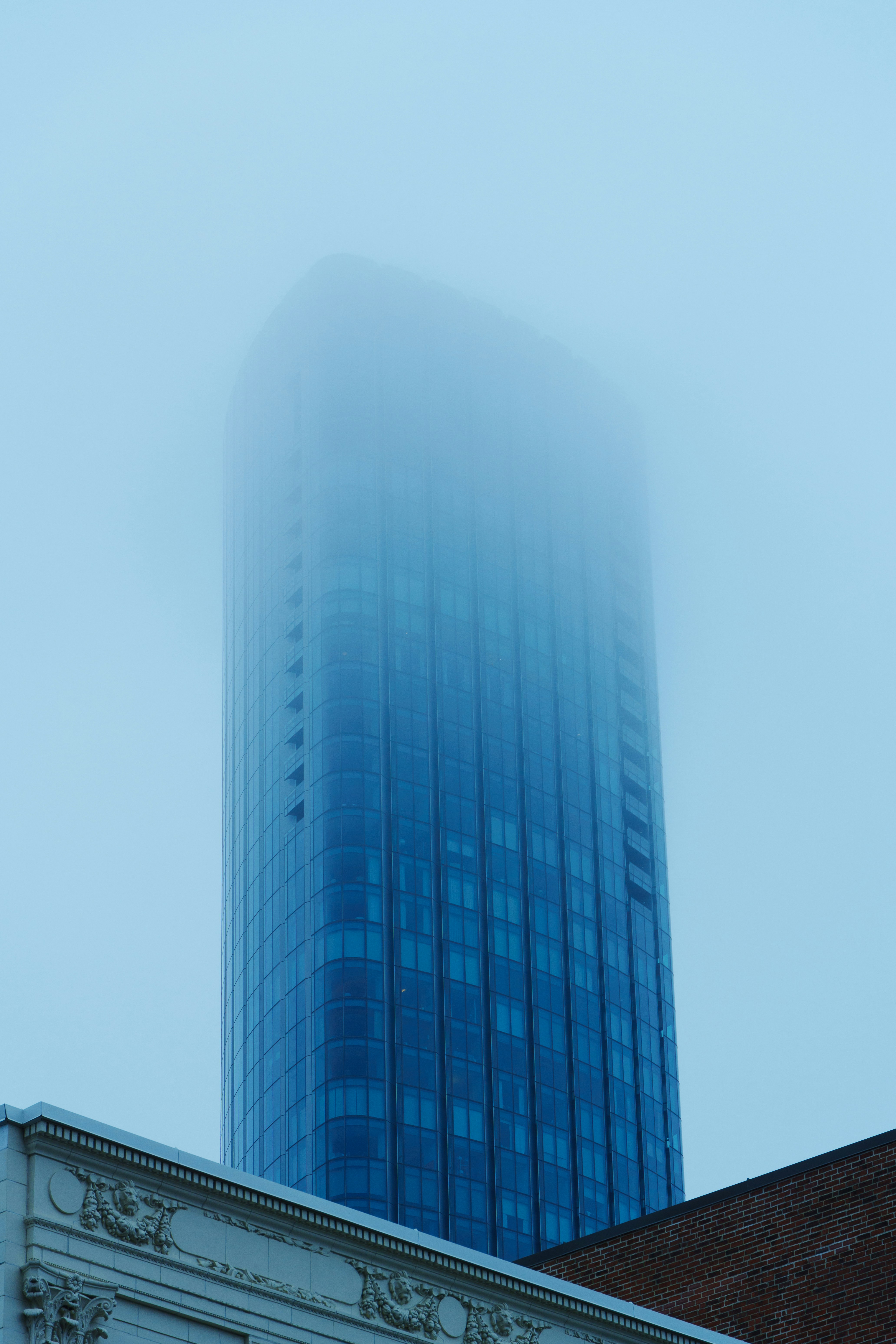 A very tall building with a very foggy sky behind it
