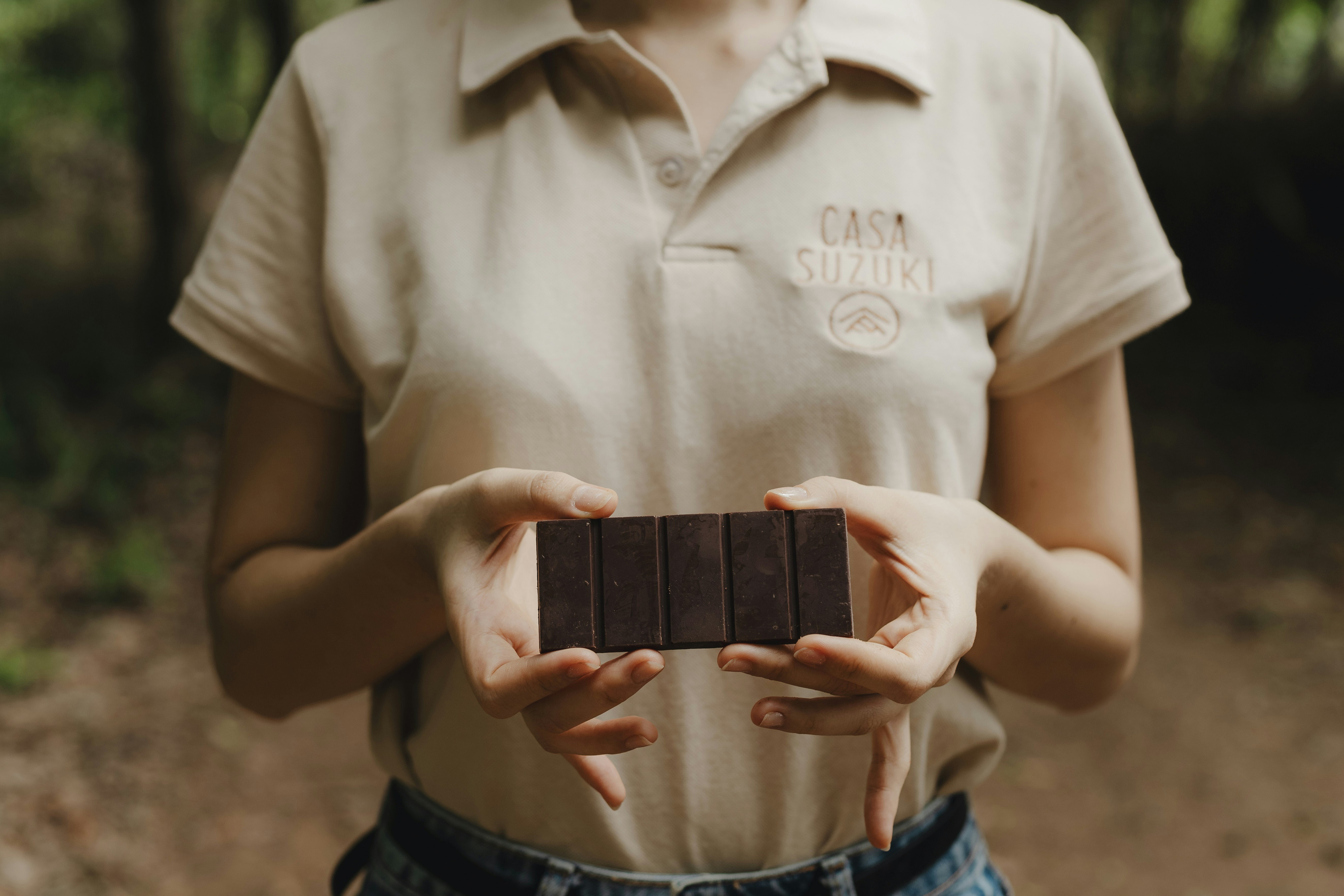 A woman holding a chocolate bar in her hands