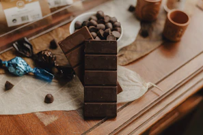 A table topped with a bowl of chocolate