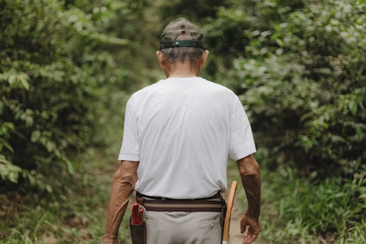 A man walking down a path in the woods