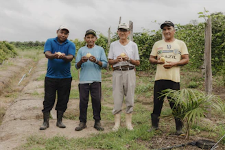 A group of men standing next to each other on a dirt road