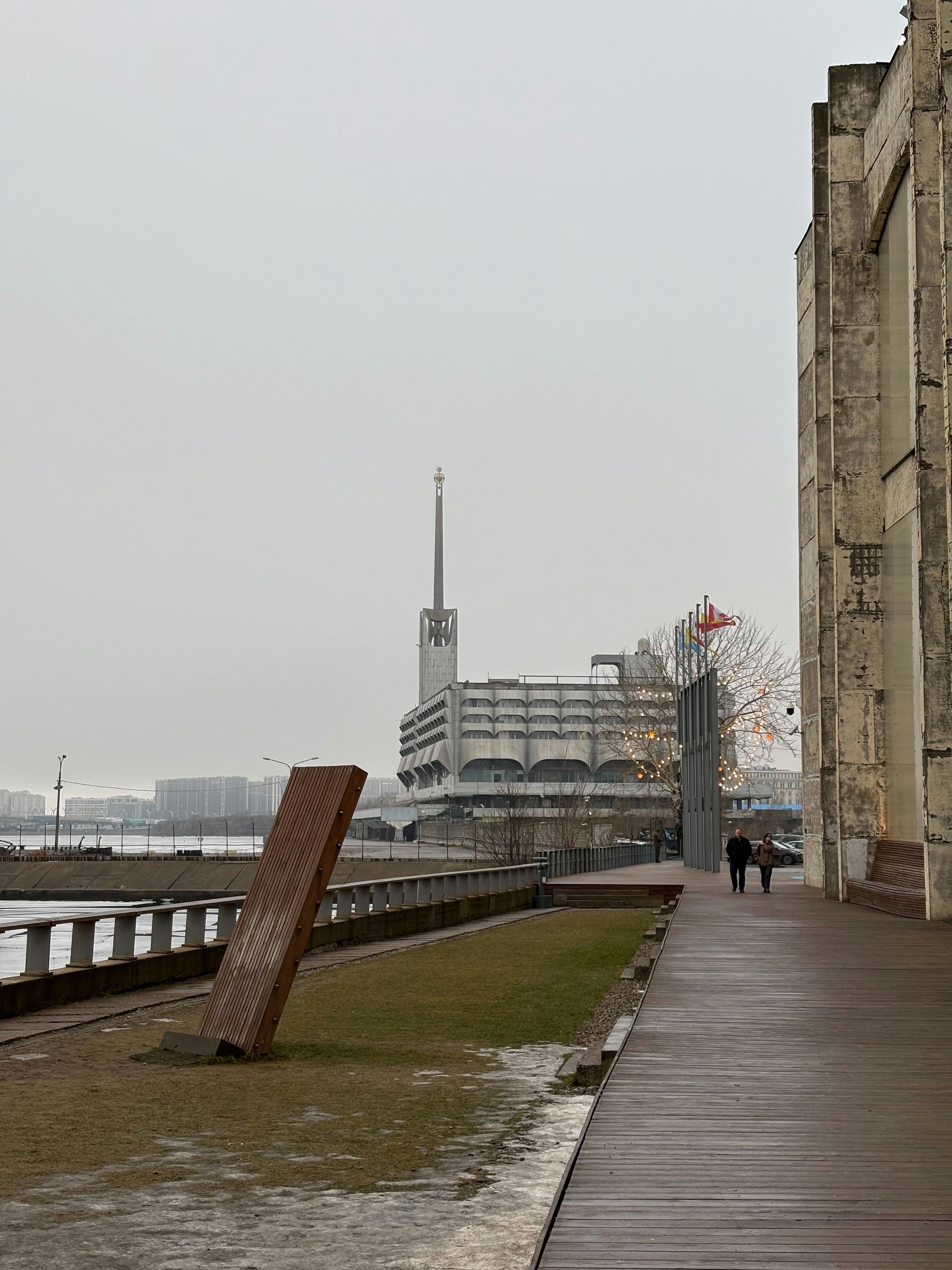 A tall building next to a body of water