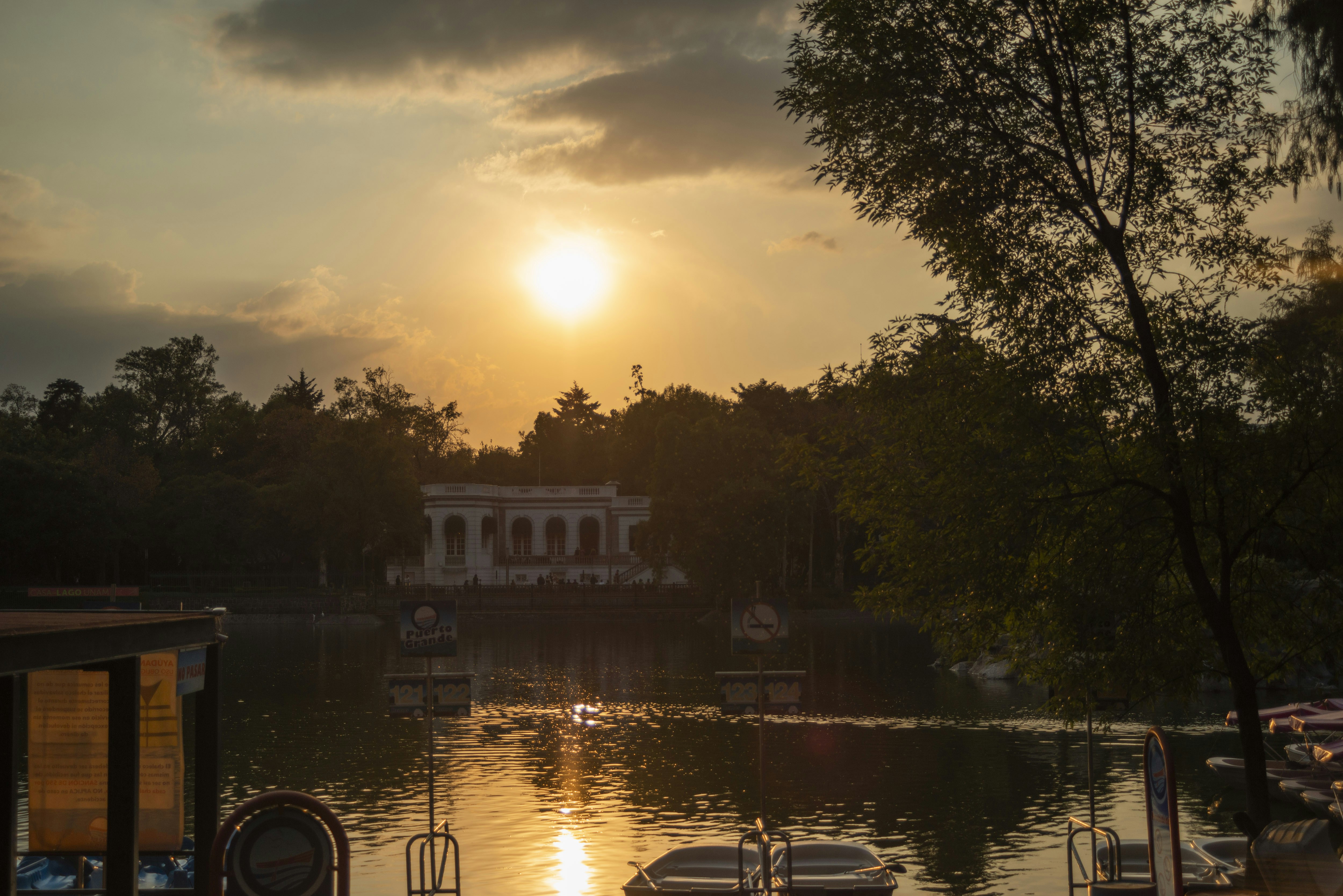 A sunset over a body of water with boats in it