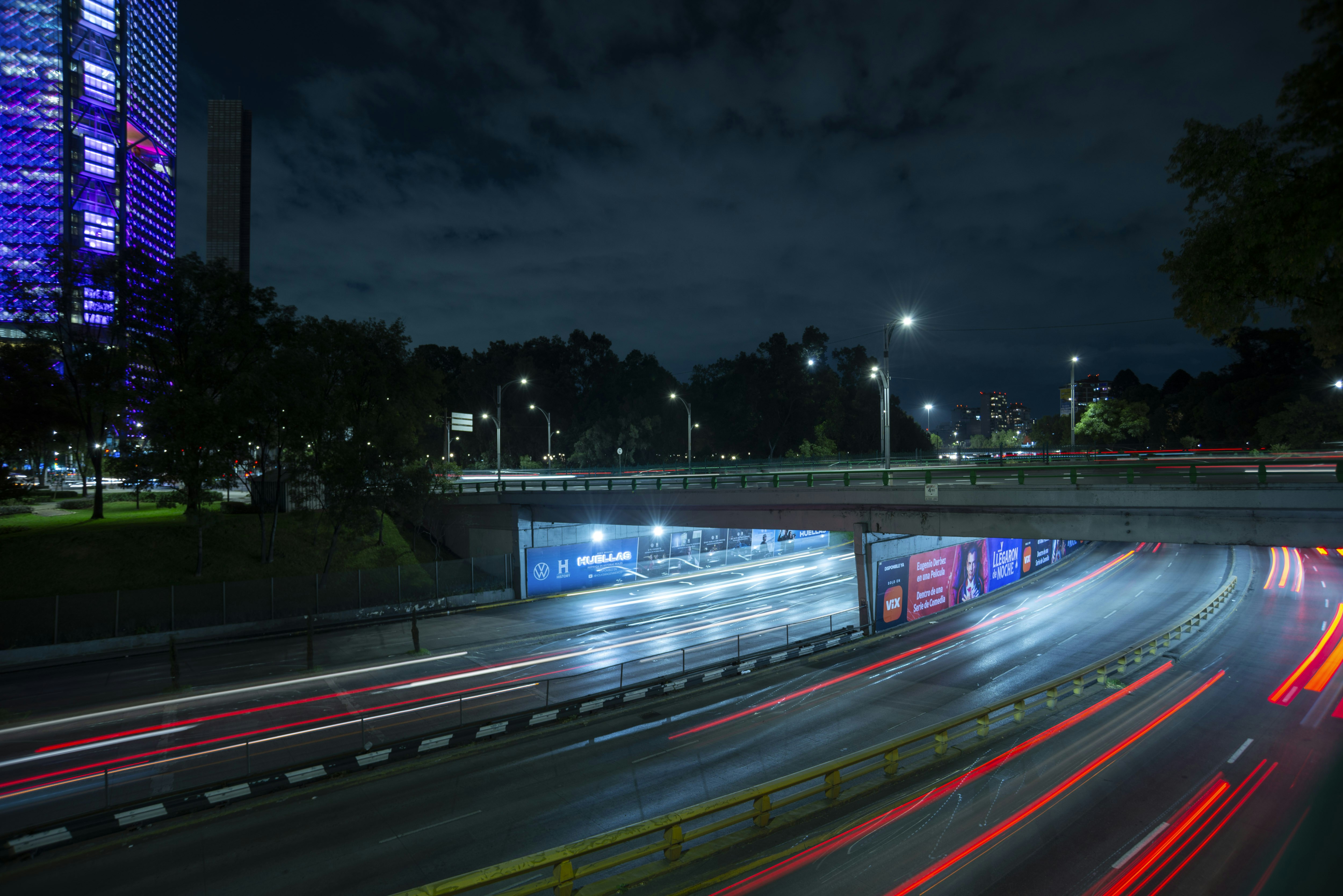 A long exposure photo of a highway at night