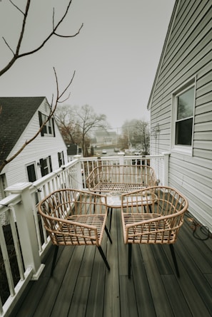 A couple of chairs sitting on top of a wooden deck