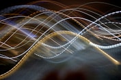 A blurry photo of a wave of light