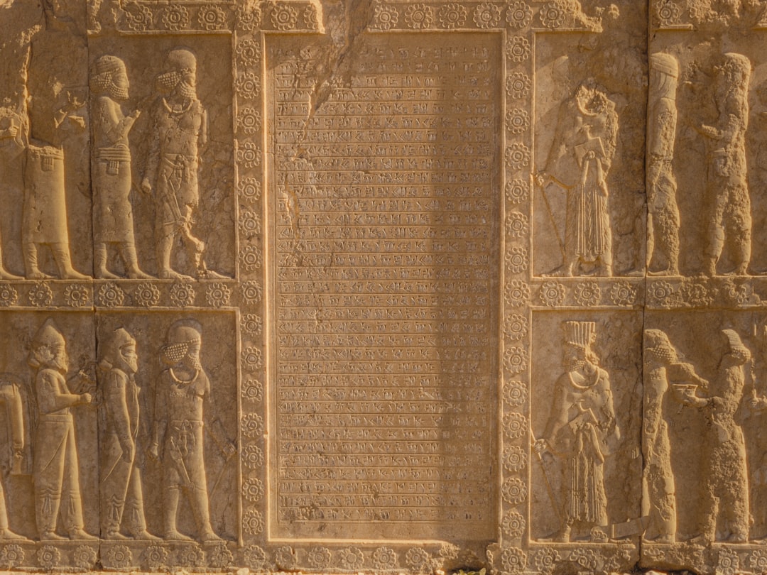 A close up of a stone wall with carvings on it, Tachara Palace in Persepolis, Shiraz, Iran