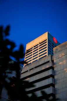 A tall building with a red sign on top of it