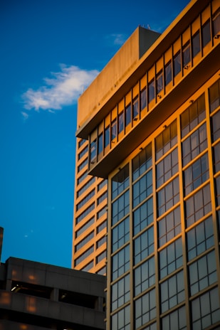 A tall building with lots of windows next to other buildings