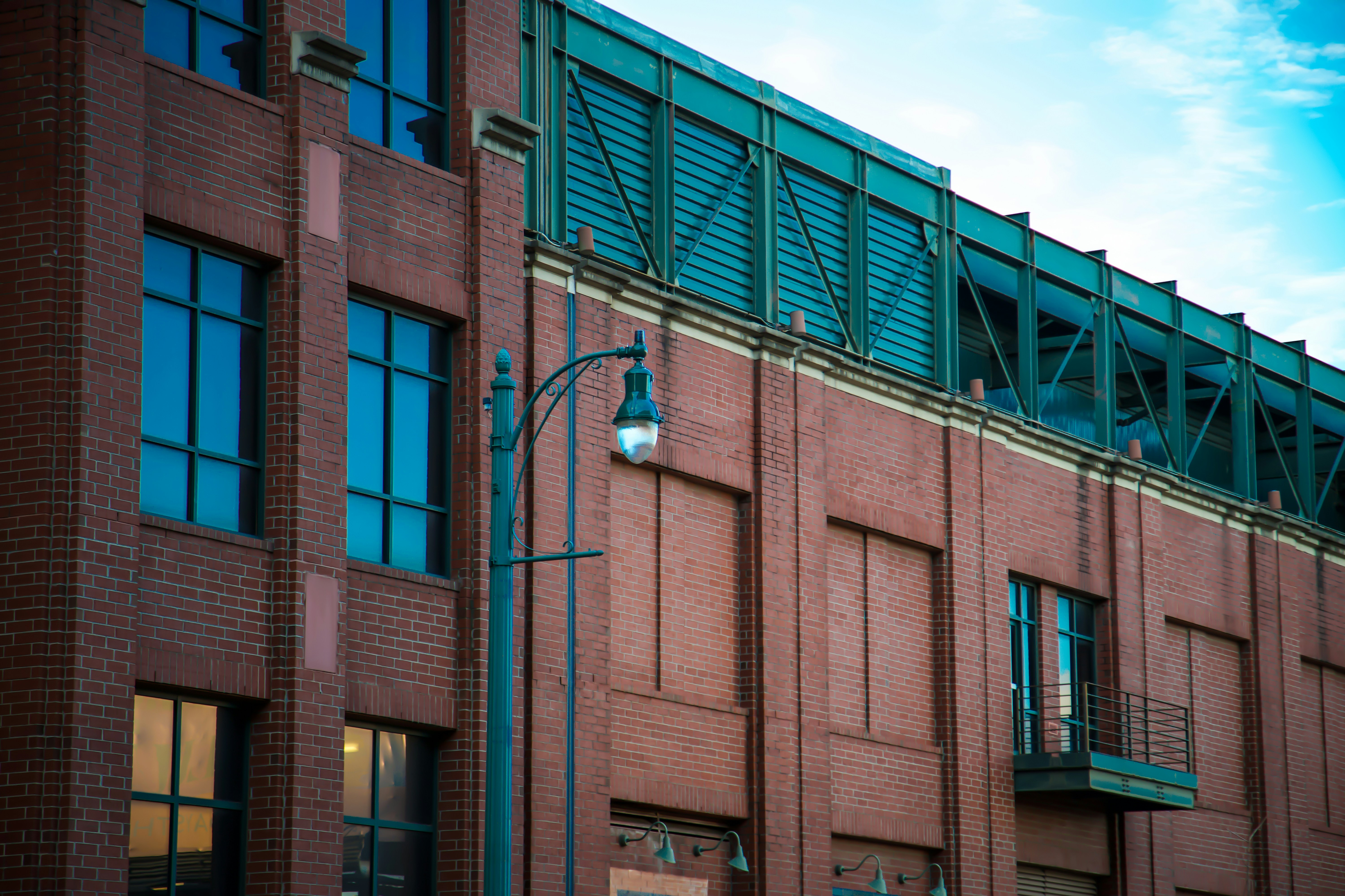 A tall building with lots of windows and a street light