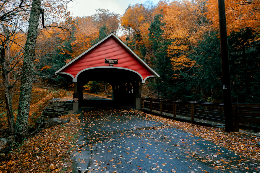 A covered bridge surrounded by New England fall foliage