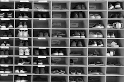 A shelf filled with lots of pairs of shoes