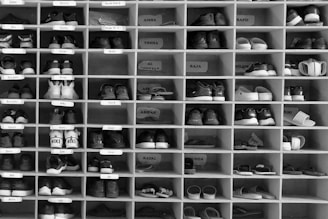 A shelf filled with lots of pairs of shoes