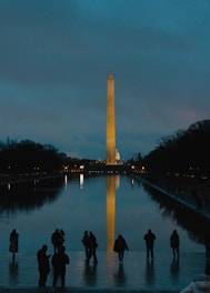 A group of people standing in front of the washington monument