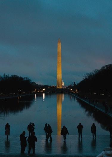 A group of people standing in front of the washington monument