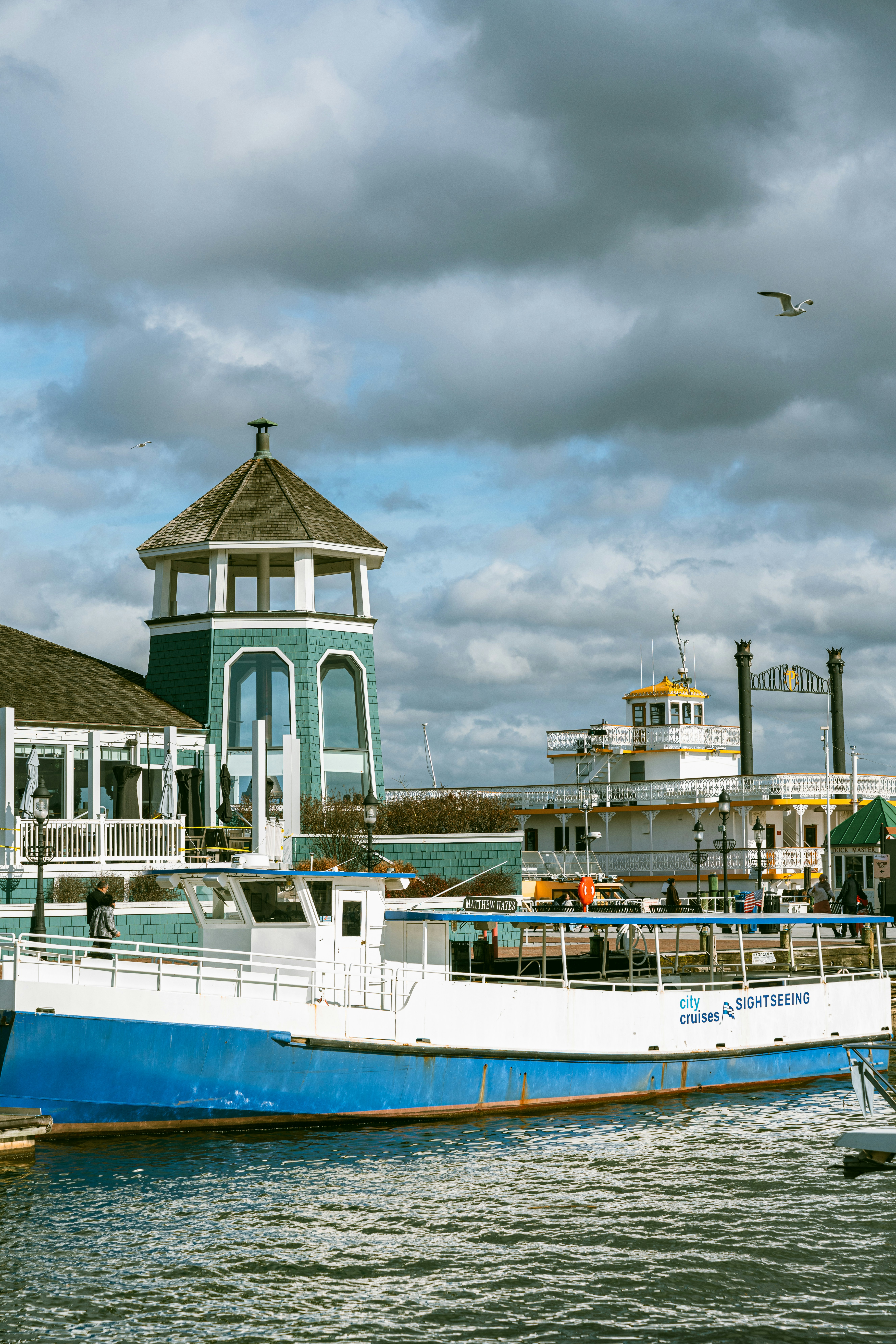 A blue and white boat docked at a pier