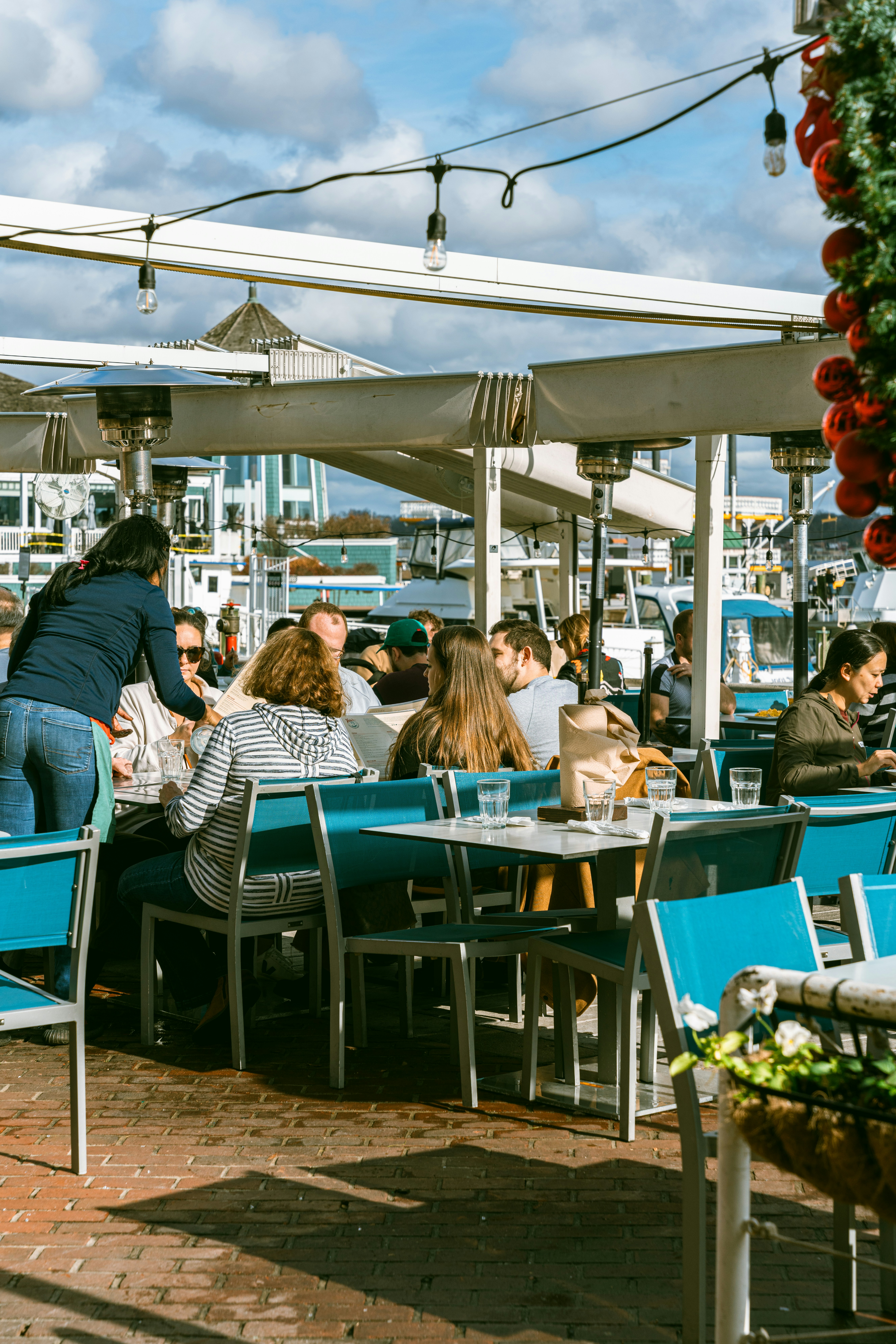 A group of people sitting at tables under umbrellas