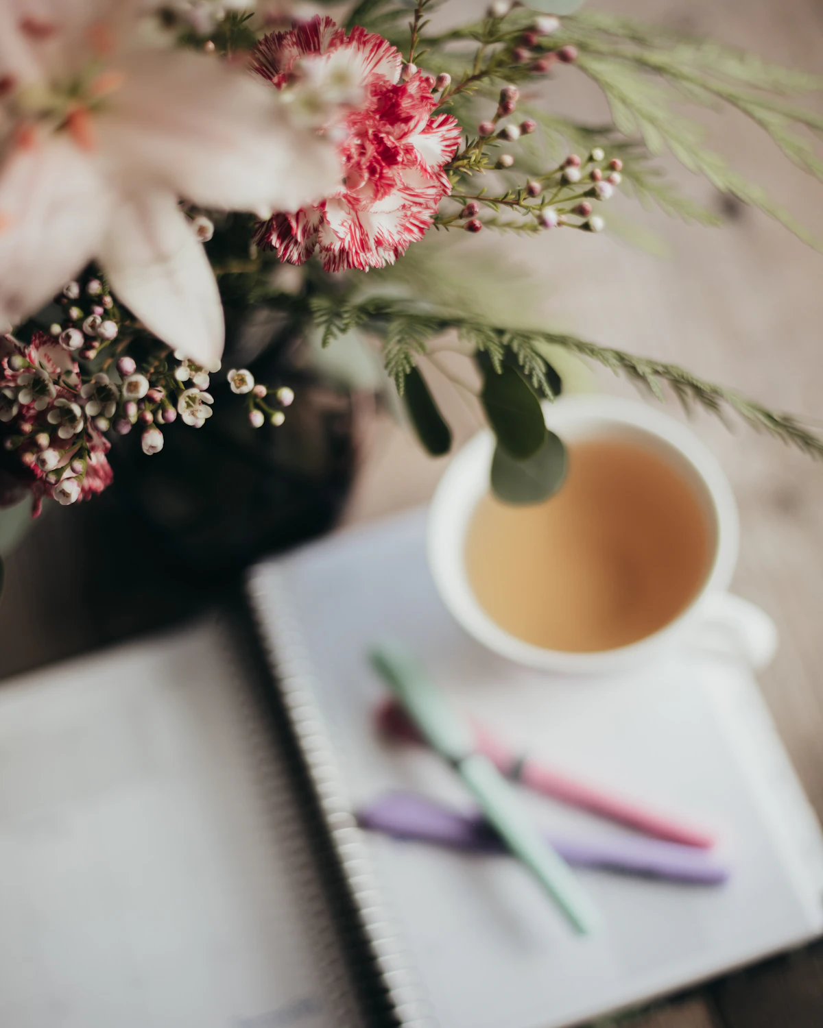 Cup of coffee beside a notebook