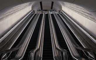 An escalator in a subway station with two escalators