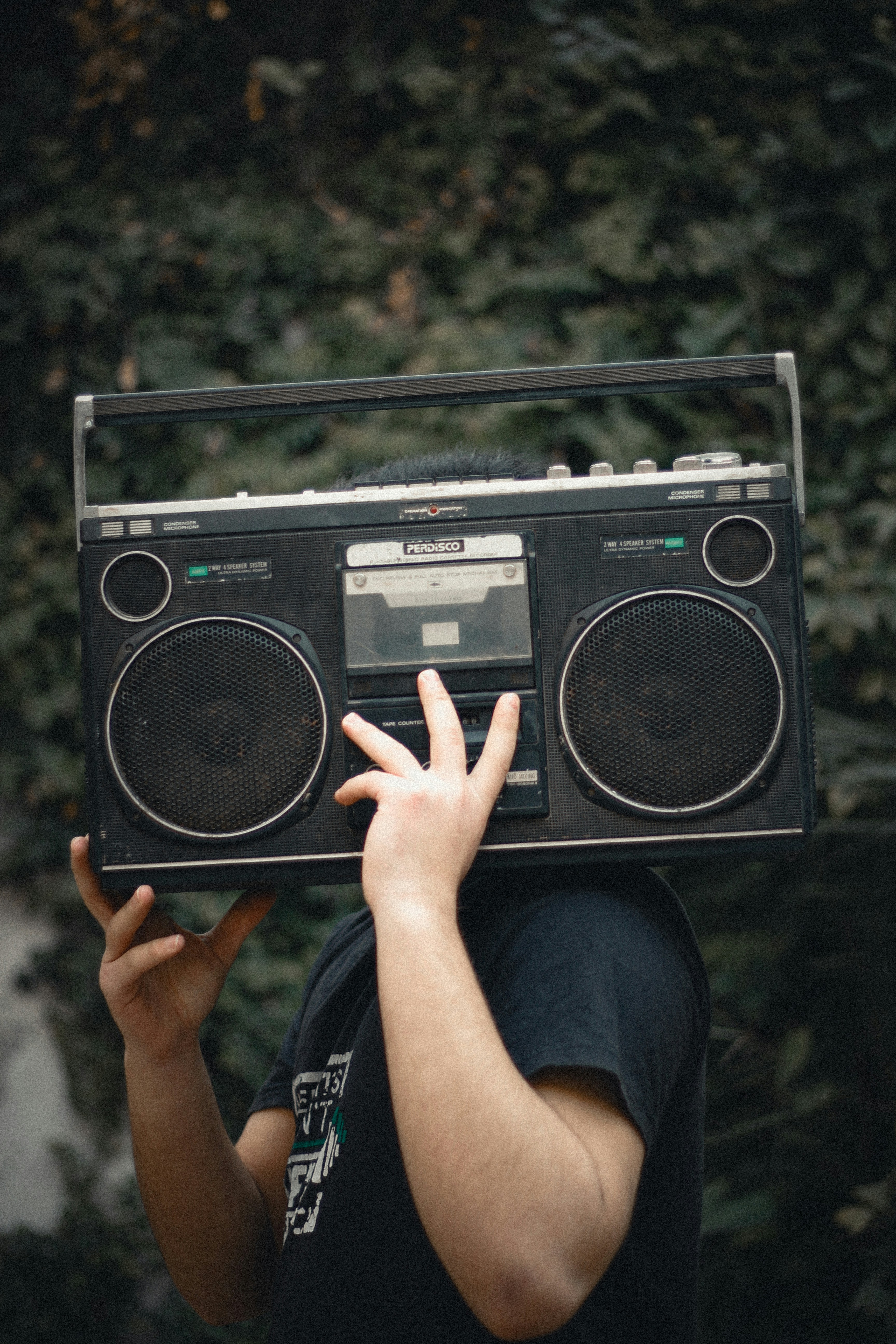 A man holding a boombox over his head
