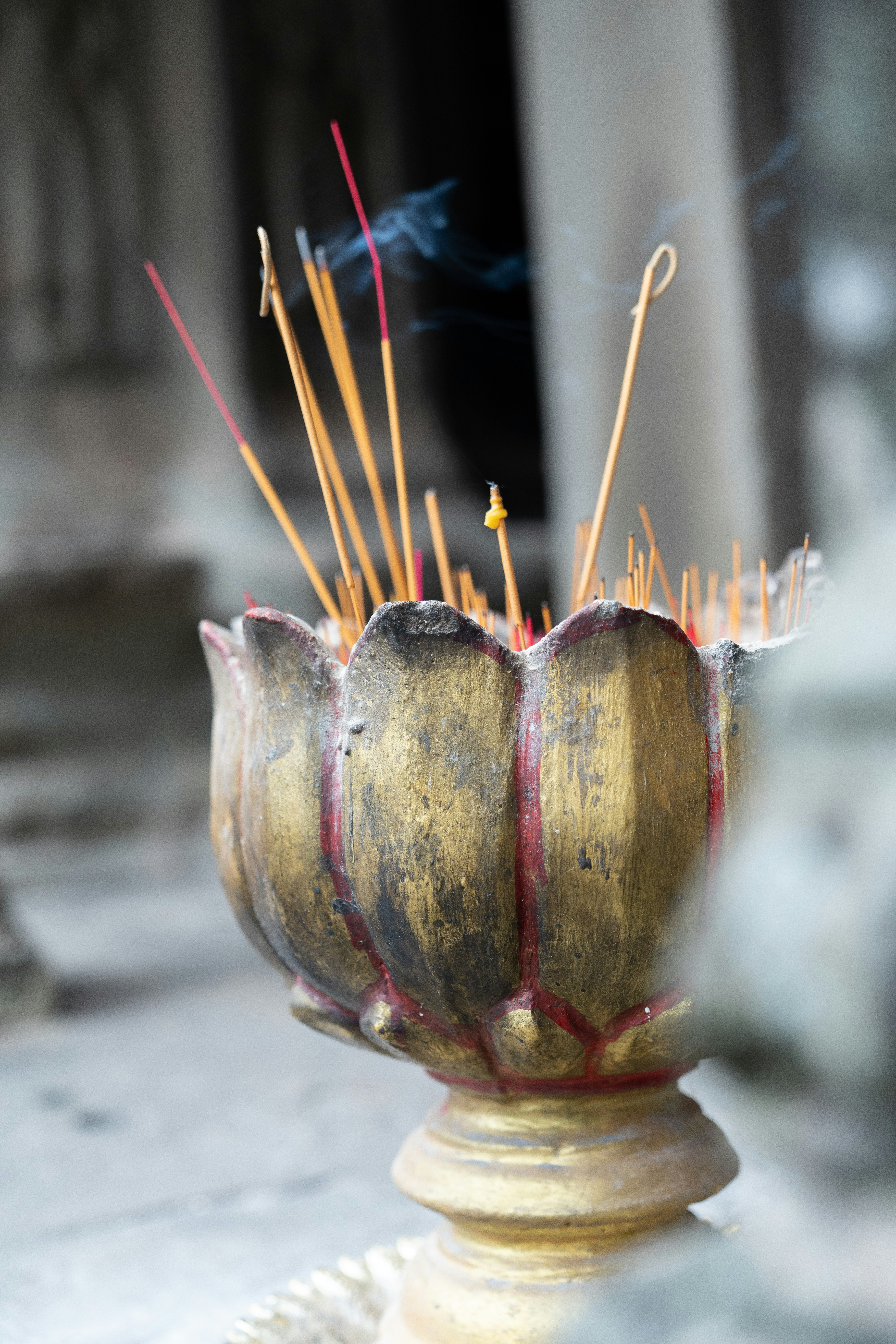 Incense sticks sticking out of a brass vase