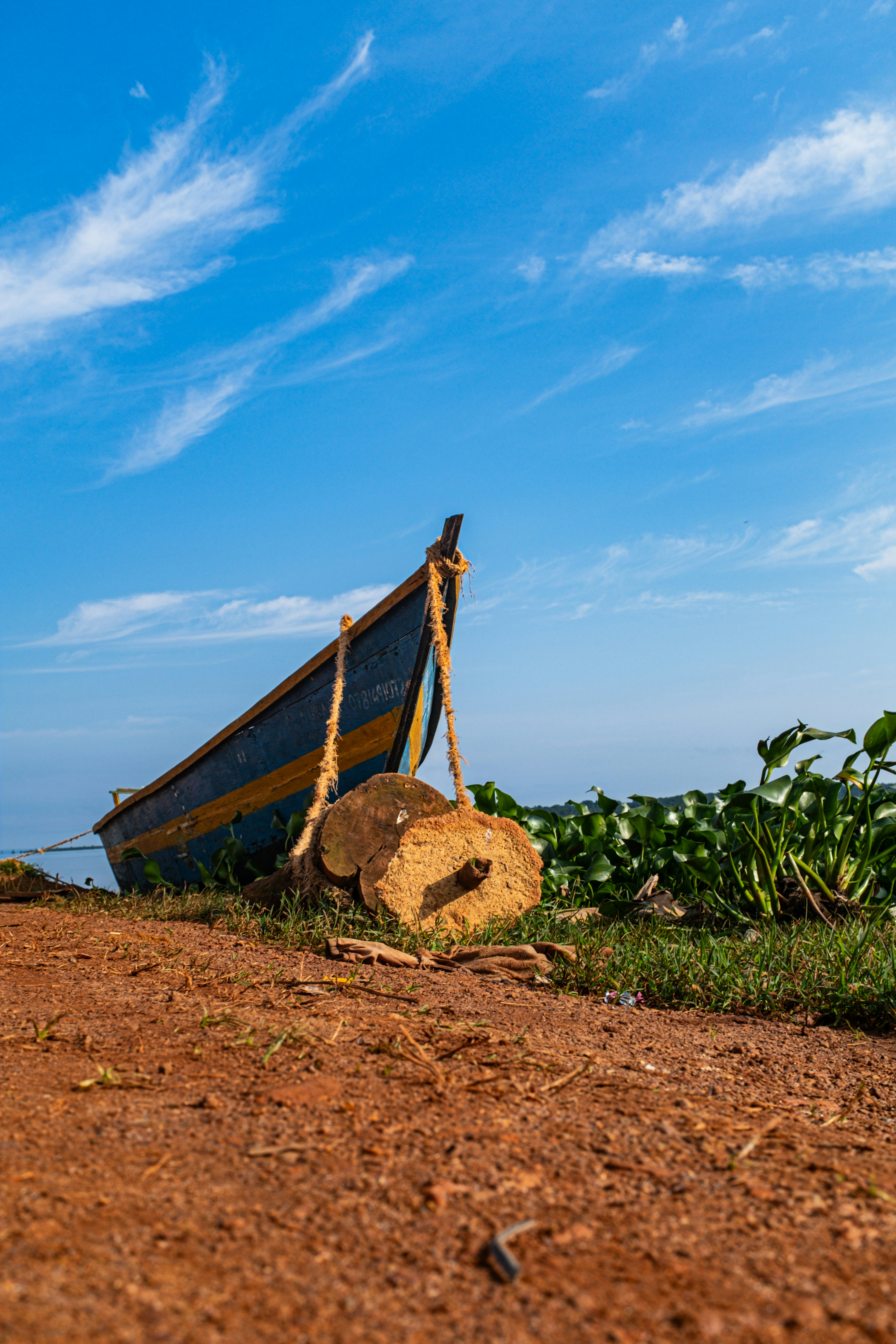 A boat sitting on top of a dirt field